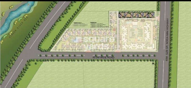 Amrapali-Riverview_an aerial view of a green field with a train on it