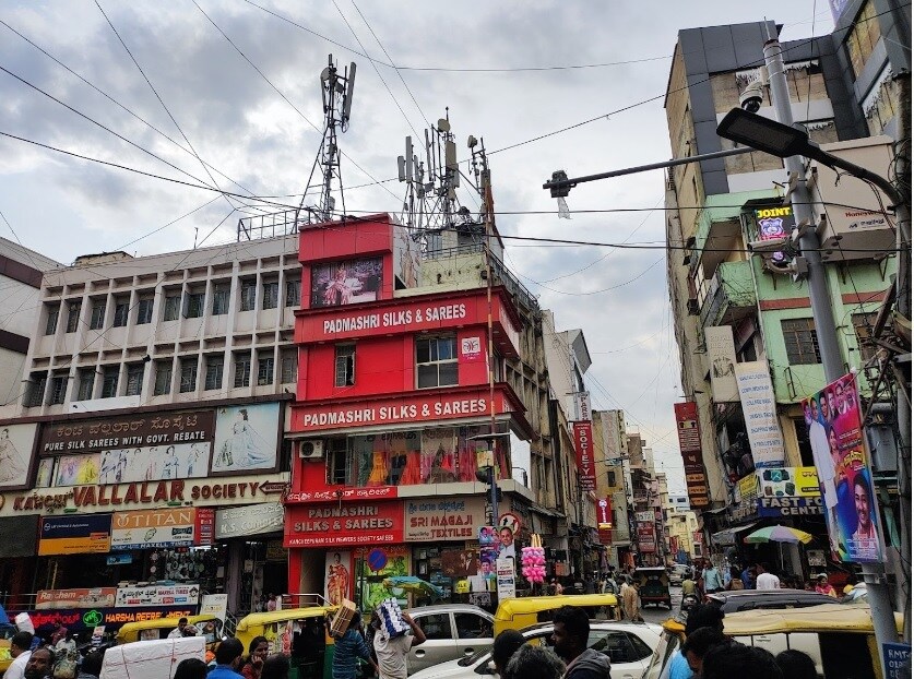 Chickpet_"a tall building with a clock on its side"