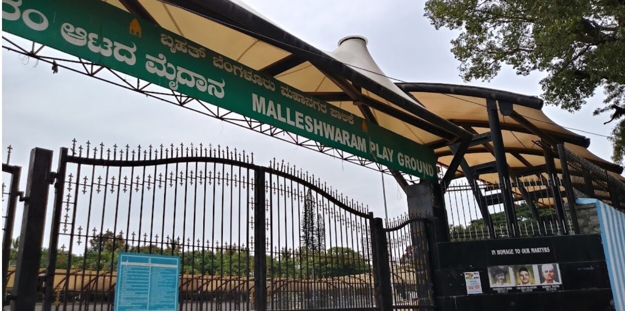 Malleswaram_a green and white street sign next to a fence