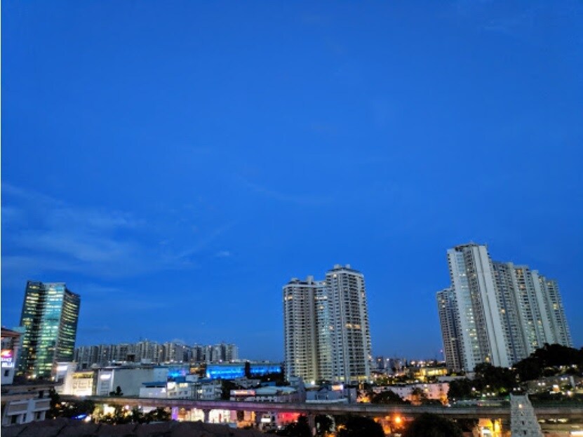 Rajaji Nagar_a city at night with skyscrapers