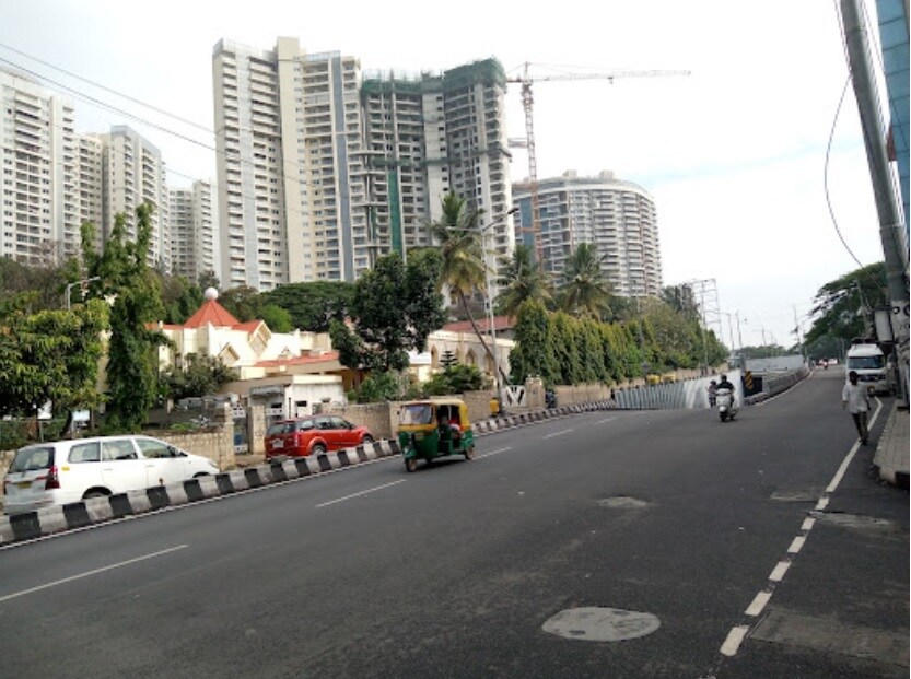 Rajaji Nagar_a truck driving down a street next to tall buildings