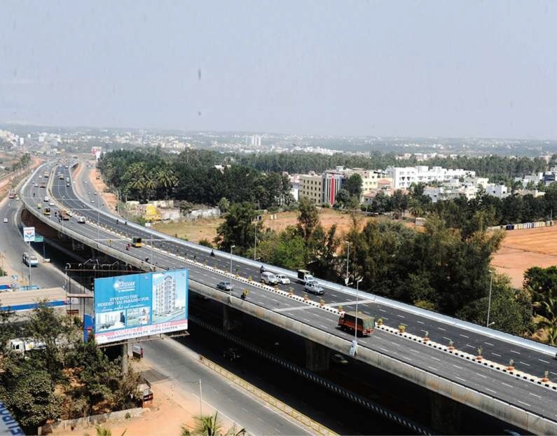 a train on a train track near a highway