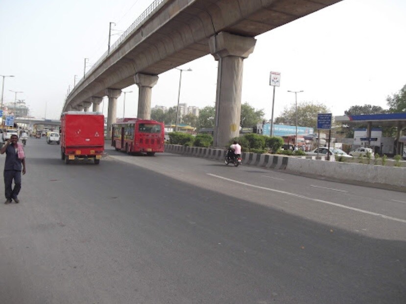 Adarsh Nagar_a red double decker bus driving down a street