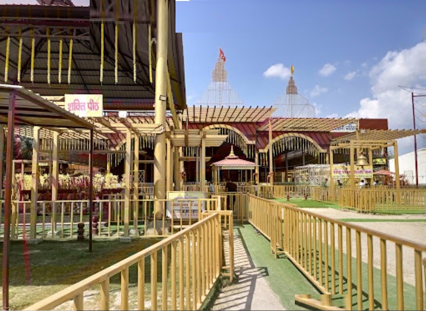 Alipur_a walkway leading to a building with a view of the ocean