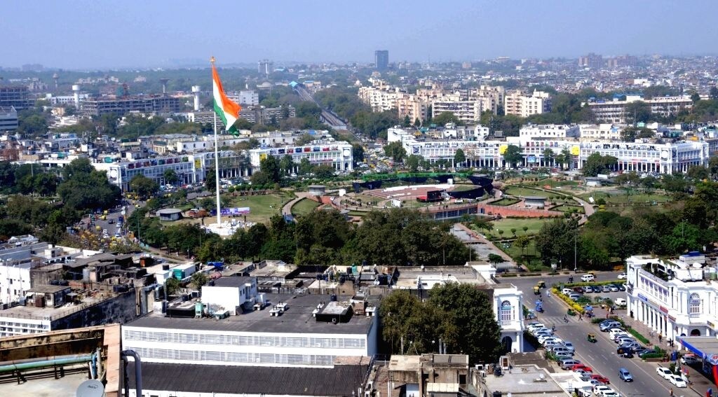 Anand Nagar_a large passenger jet flying over a city
