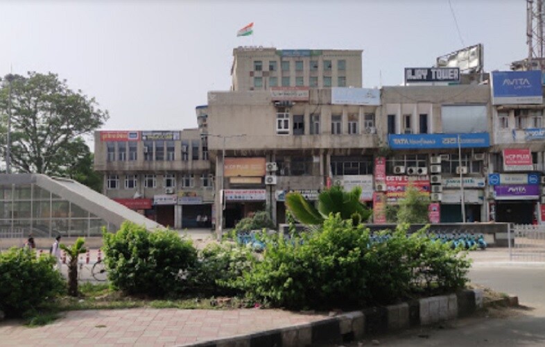 Ashok Vihar_a building with a lot of windows and a lot of trees