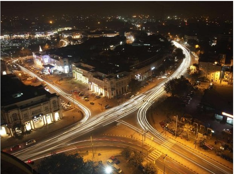 Connaught Place_a city street filled with lots of traffic at night