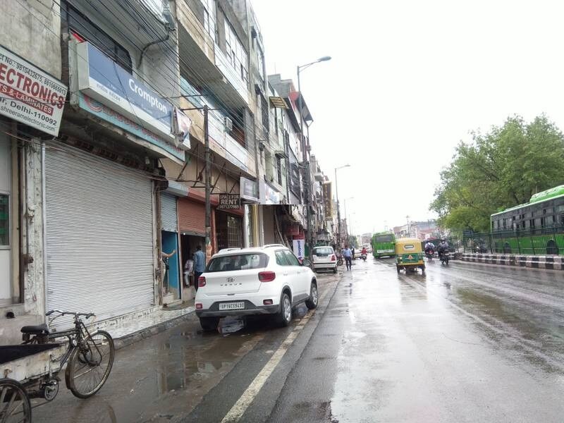 Ganesh Nagar_a city street with cars parked on the side of the road