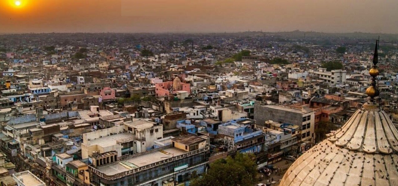 Indraprastha_a city with many tall buildings and a sky background