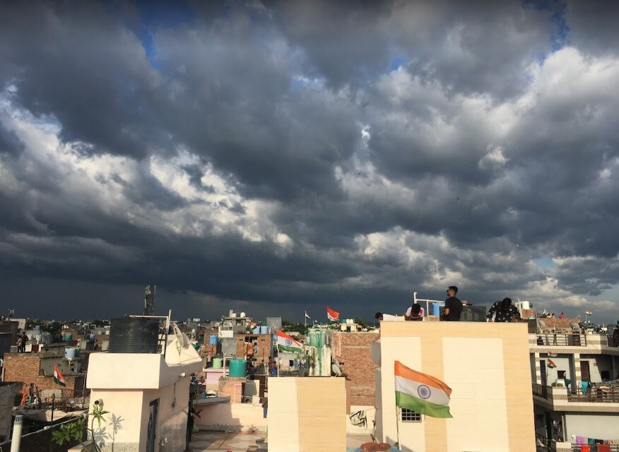 Nangloi_a cloudy sky over a city filled with buildings