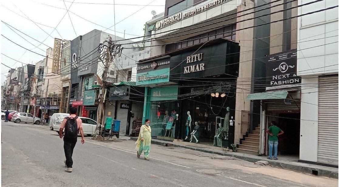 Rajouri Garden_a man walking down the street with a cane