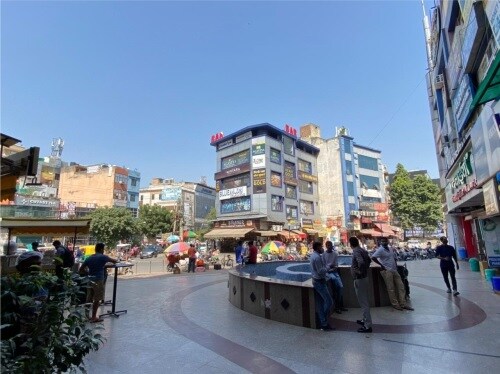 Sector 7 Dwarka_people standing around a fountain in a city