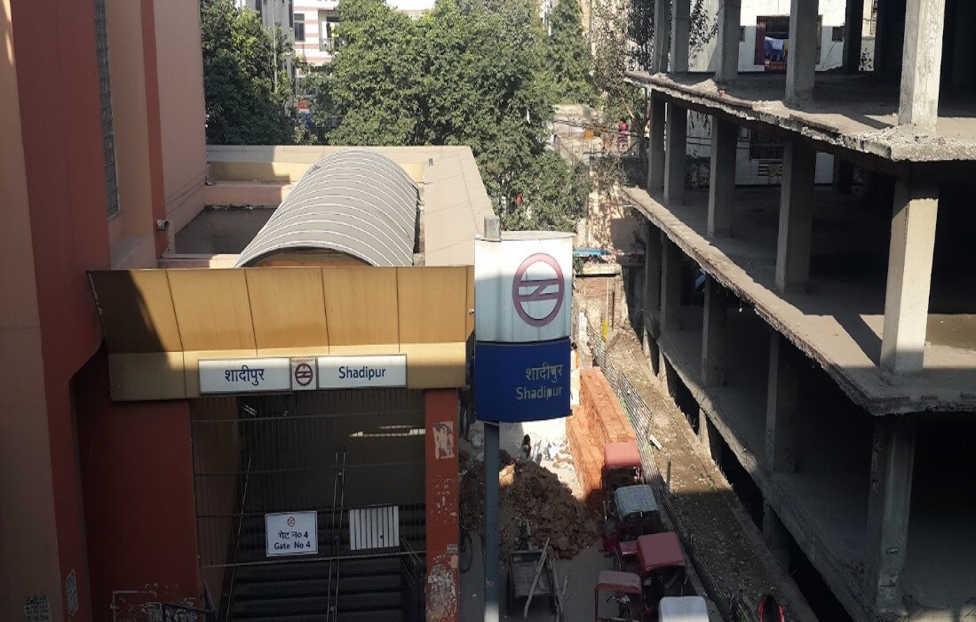 Shadipur_a garbage truck parked on the side of a building