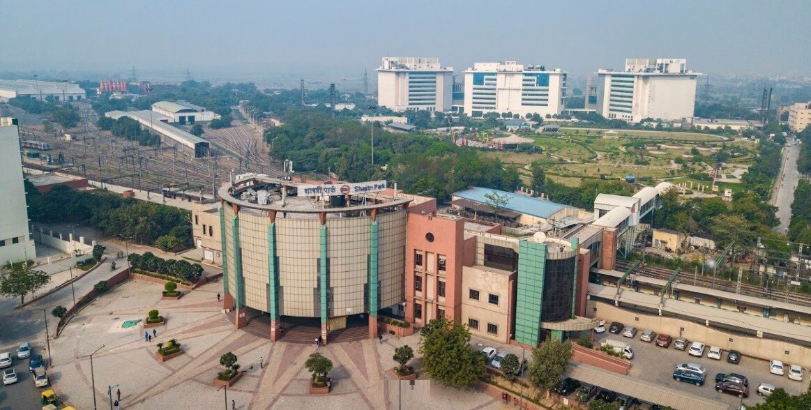 Shastri Park_a large building with a large clock on it
