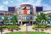 Vasant Kunj_a large building with a clock on the front of it