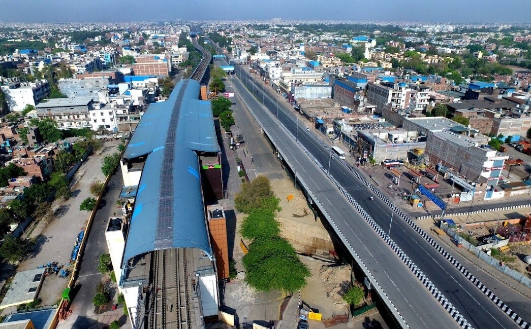 Vivek Vihar_a train is going down the tracks in a city