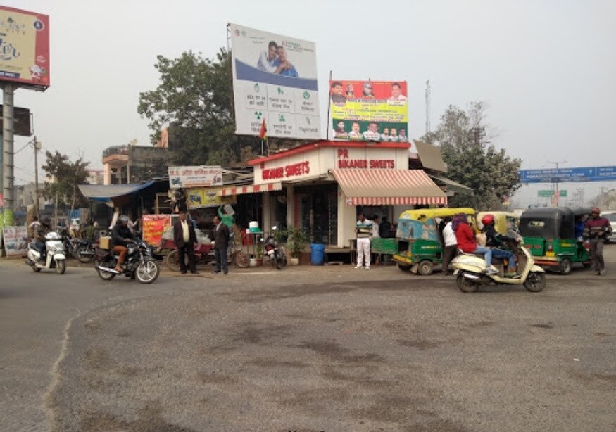 Defence Colony_motorcycles parked in front of a store