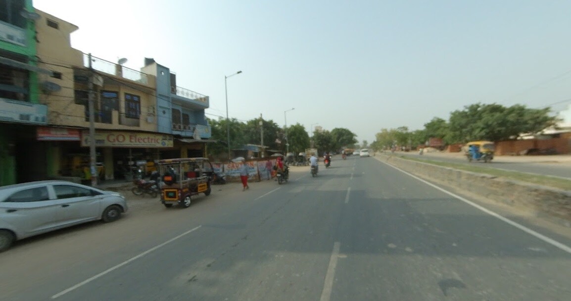 Govindpuri_a street filled with lots of cars and people
