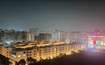 Raj Nagar Extension_a city at night with many tall buildings