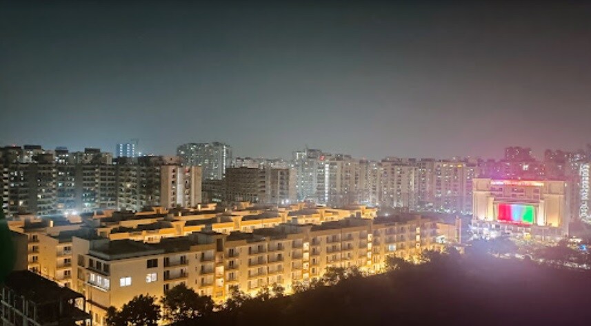 Raj Nagar Extension_a city at night with many tall buildings