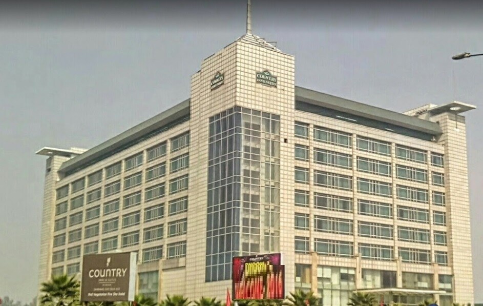 Sahibabad_a tall building with a clock on top of it