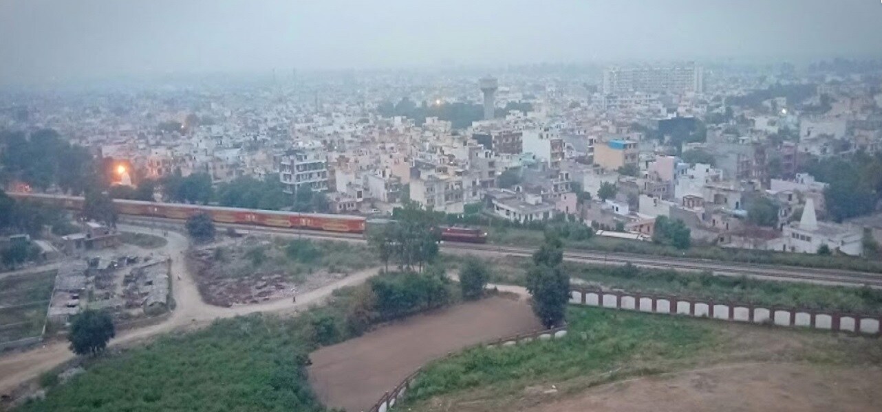 Shastri Nagar_a train on a train track in the middle of a city