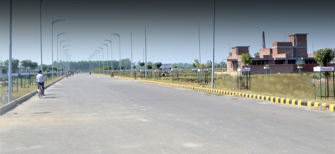 Vikas Nagar_a man walking down a street next to a road