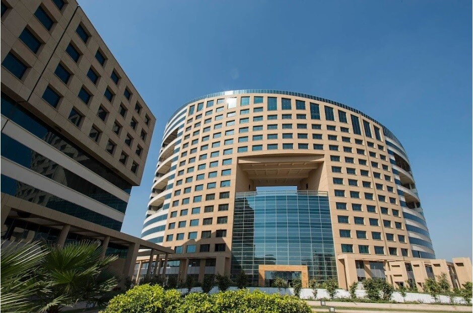 IMT Manesar_a tall building with a clock on the top of it