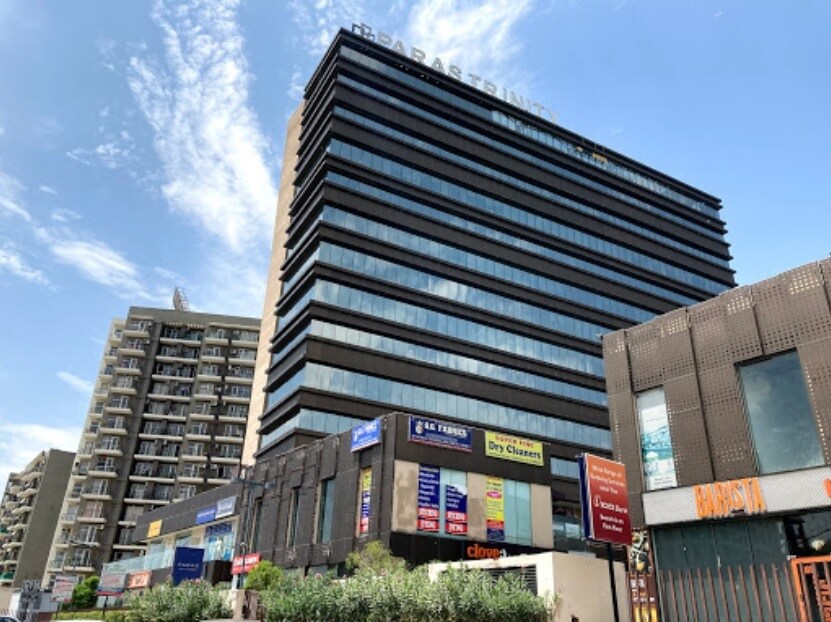 Sector 63_a tall building with a large building behind it