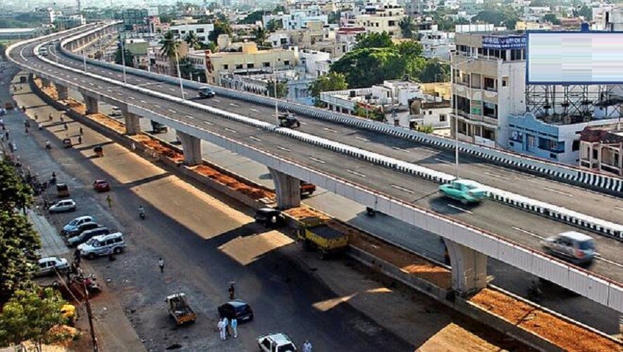 Attapur_a train traveling over a bridge over a city