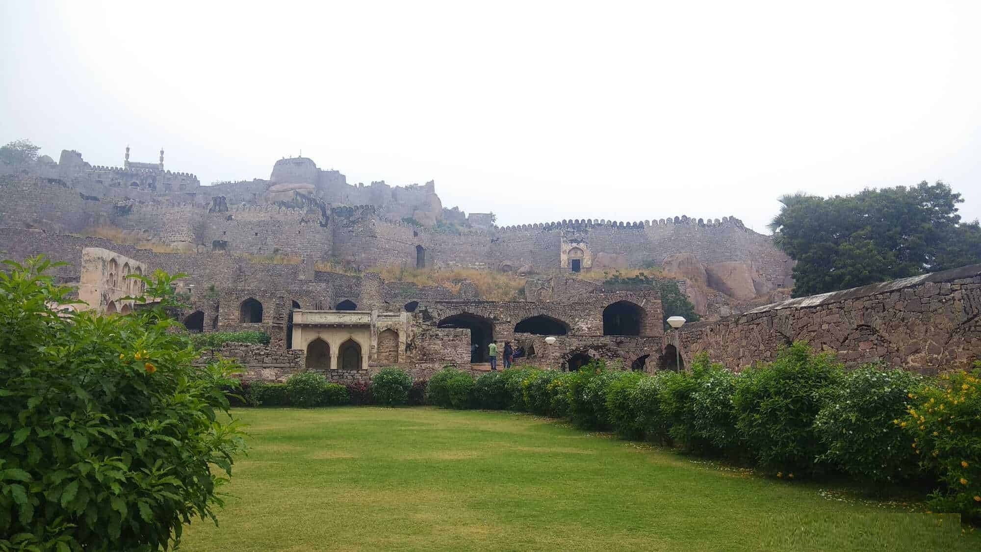Bowenpally_a large stone building with a bunch of trees around it