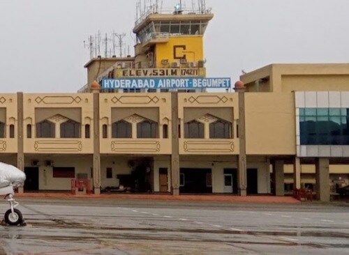 Gandhi Nagar_a large white plane parked in front of a building