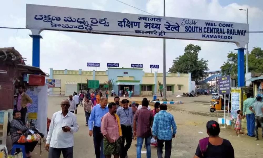 Kamareddy_a crowd of people standing on a street corner