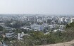 Khammam_a city with lots of tall buildings and trees