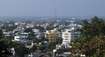 Khammam_a city with lots of tall buildings and trees