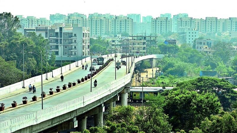 Lingampally_a train crossing a bridge over a city