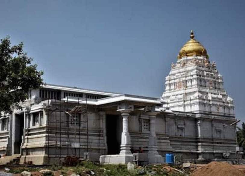 Maruthi Nagar_a large white building with a clock on top