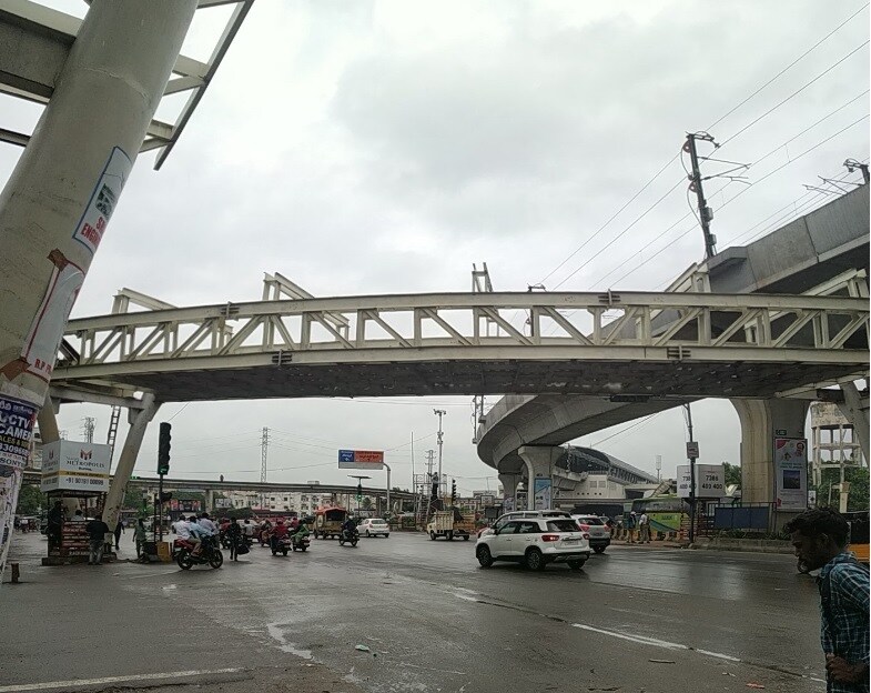 Uppal_a large truck driving down a street next to a bridge