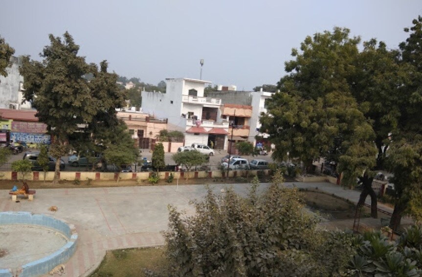 Adarsh Nagar_a street scene with trees and buildings