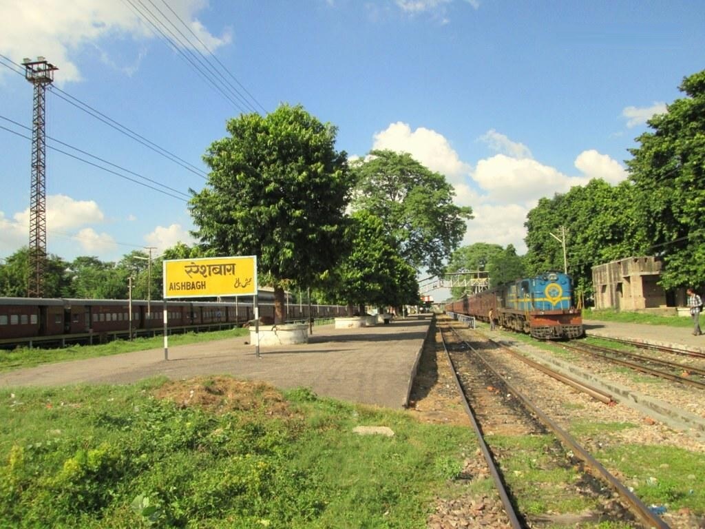 Aishbagh_a train station with a train on the tracks