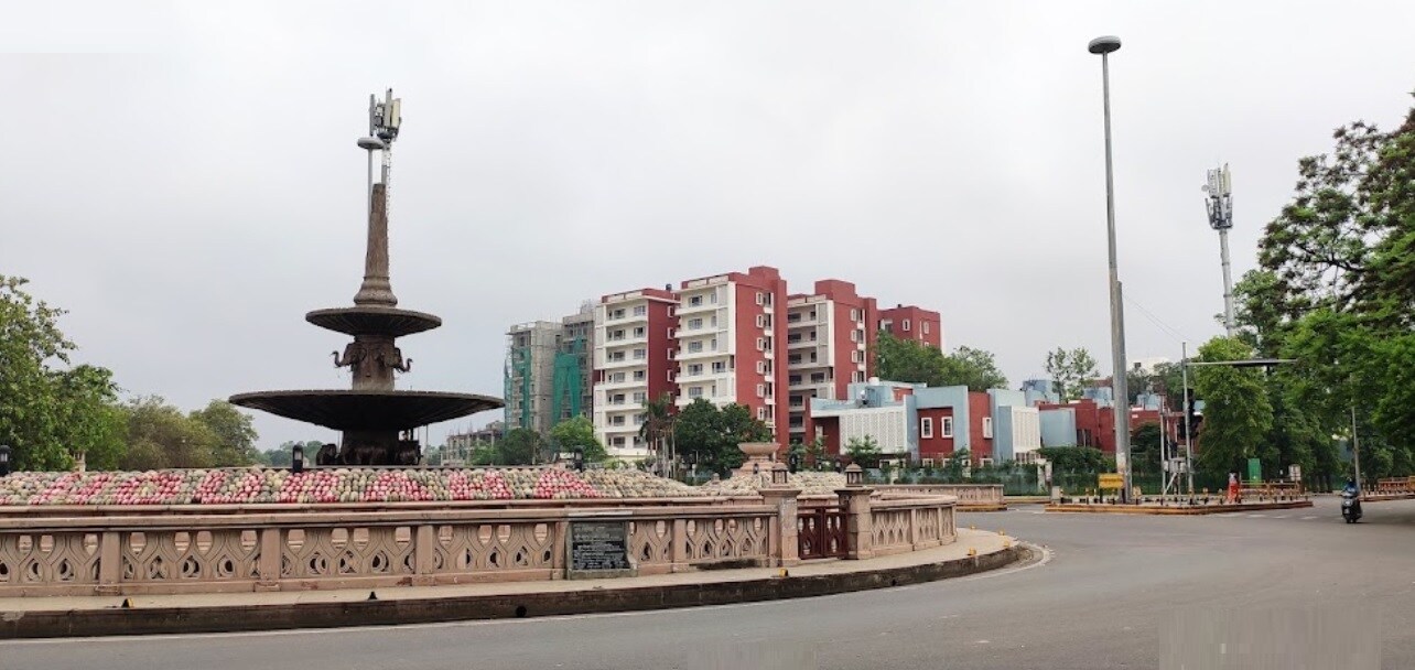 Anand Nagar_a tall building with a clock on the side of it