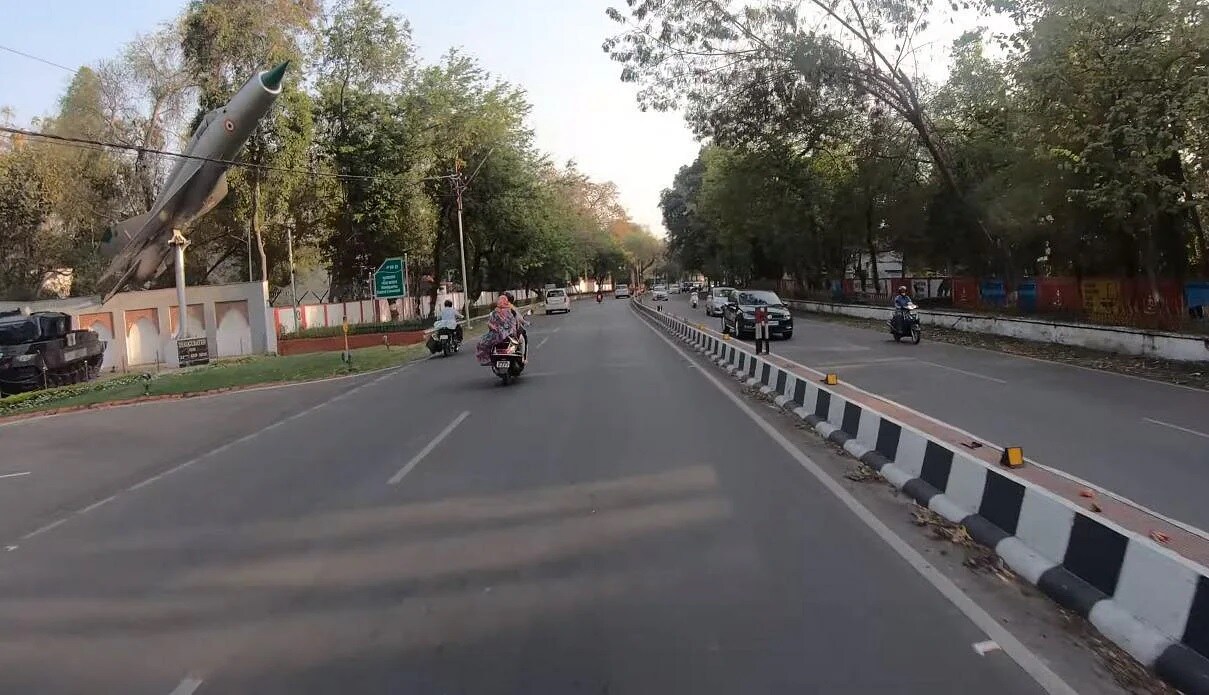 Cantonment_a man riding a motorcycle down a street