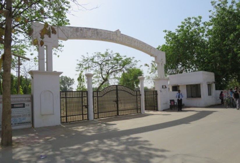 Chinhat_a road with a fence and some trees