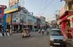 Mahanagar_a city street filled with cars and pedestrians