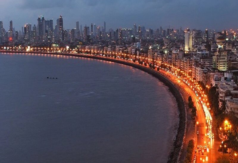 Andheri East_a city at night with a large body of water