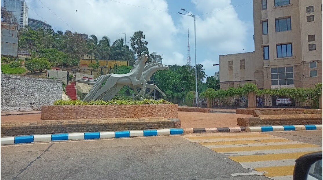 Andheri West_a statue of a man on a skateboard in front of a building