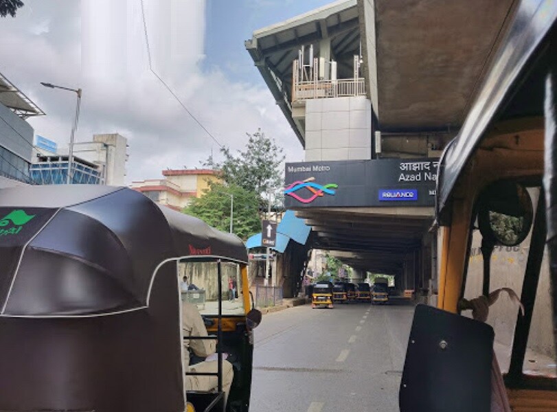 Azad Nagar_people walking down a street with umbrellas