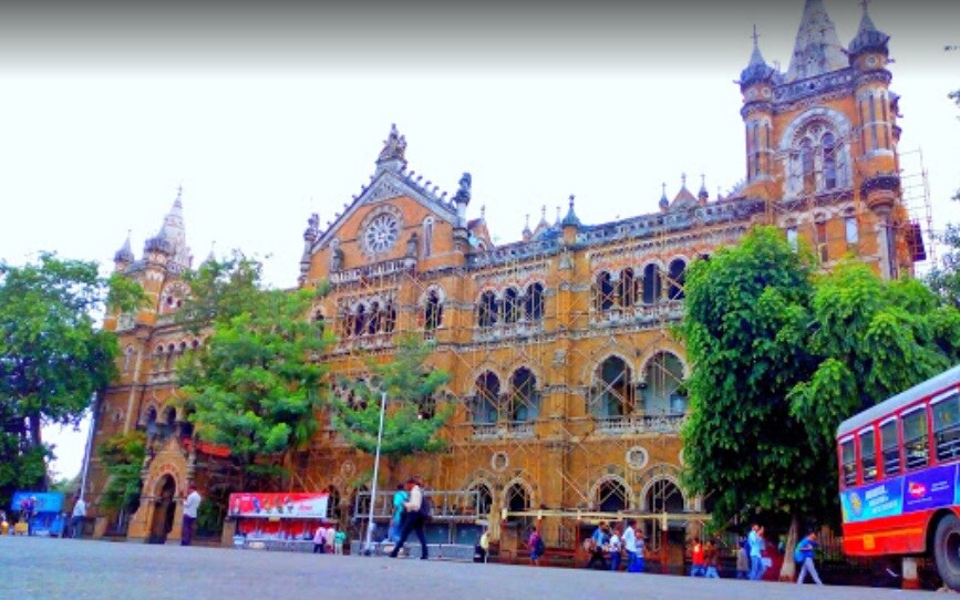 Churchgate_a large building with a clock on the side of it