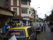 Kamathipura_a city street filled with lots of parked cars