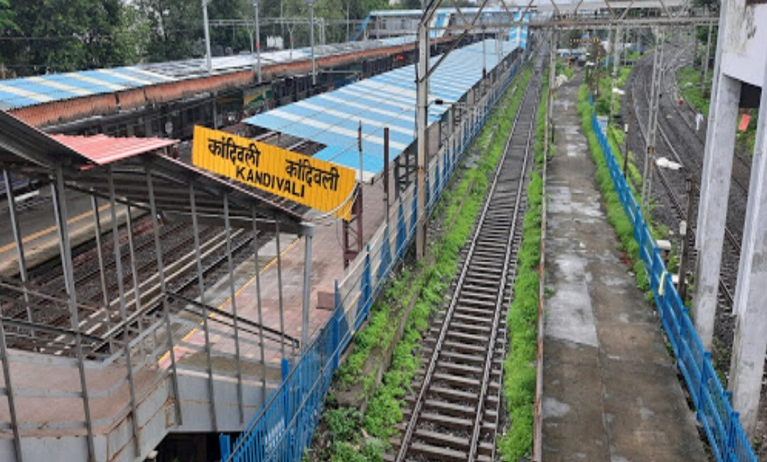 Kandivali East_a train yard filled with train tracks next to a building